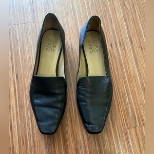 Naturalizer black soft leather loafer with metallic detail on sole.